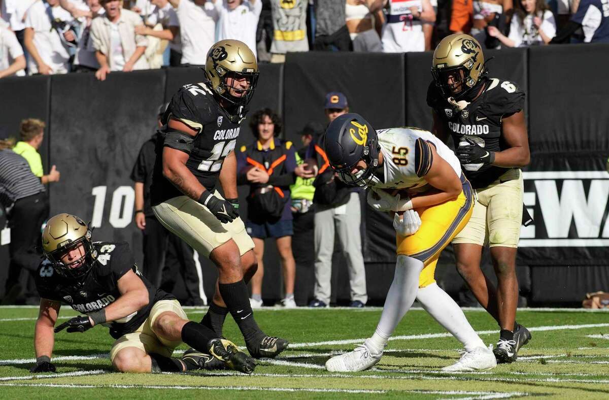 California tight end Keleki Latu, front right, misses a pass on fourth down to end overtime of an NCAA college football game as, from left to right, Colorado safety Trevor Woods, linebacker Quinn Perry and cornerback Nikko Reed cover at Folsom Field, Saturday, Oct. 15, 2022, in Boulder, Colo. (AP Photo/David Zalubowski)