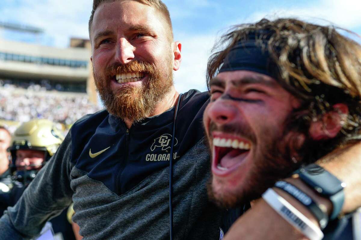 BOULDER, CO - OCTOBER 15: Interim head coach Mike Sanford of the Colorado Buffaloes celebrates in a scrum on the field after an overtime win against the California Golden Bears at Folsom Field on October 15, 2022 in Boulder, Colorado. (Photo by Dustin Bradford/Getty Images)