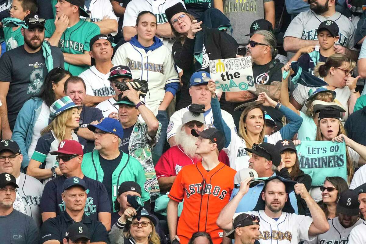A lone Houston Astros fan is surrounded by a sea of Seattle Mariners fans during the 12th inning of Game 3 of the American League Division Series on Saturday, Oct. 15, 2022, in Seattle.