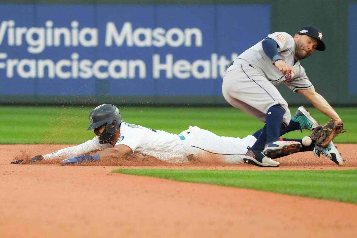 The ball hits Seattle Mariners center fielder Julio Rodriguez (44) as he steals second as Houston Astros second baseman Jose Altuve (27) covers the bag during the 13th inning of Game 3 of the American League Division Series on Saturday, Oct. 15, 2022, in Seattle.
