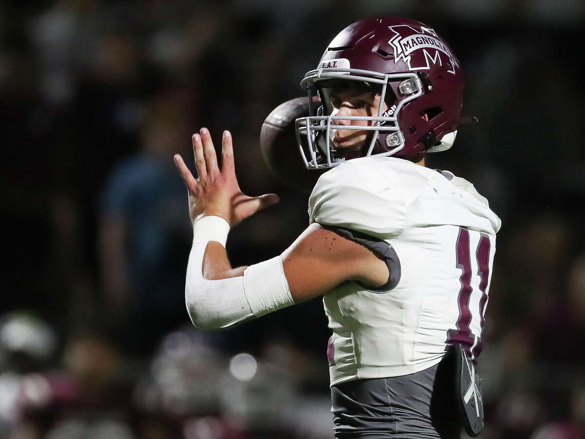 Magnolia quarterback Tanner Whittington (11) drops back to throw a 8-yard touchdown in the fourth quarter of a District 10-5A (Div. I) high school football game at Edward Mercer Stadium, Saturday, Oct. 15, 2022, in Sugar Land.