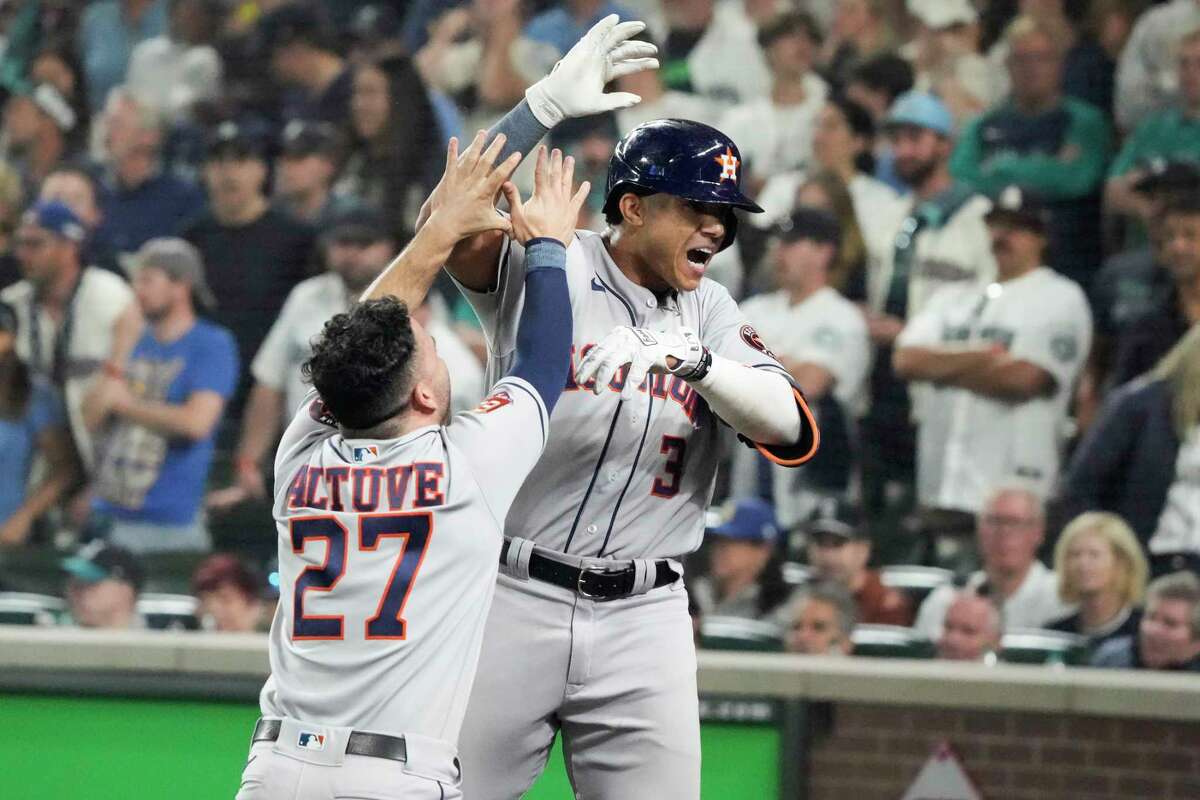 Houston Astros shortstop Jeremy Peña (3) and Jose Altuve celebrate Peña’s solo home run against the Seattle Mariners during the 18th inning of Game 3 of the American League Division Series on Saturday, Oct. 15, 2022, in Seattle.