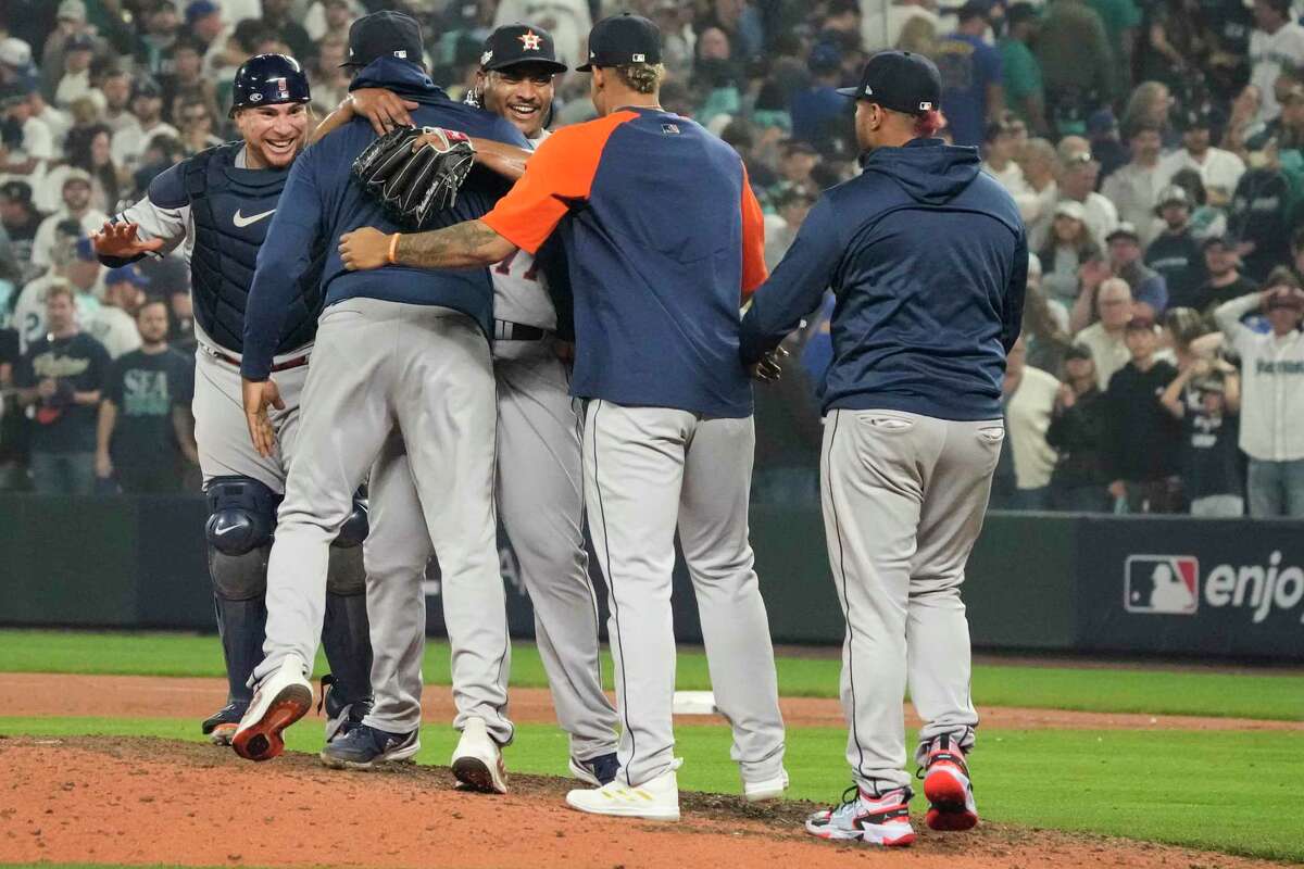 Houston Astros starting pitcher Luis Garcia (77) celebrates with his teammates after closing out the Seattle Mariners in a 1-0 win, in 18 innings, in Game 3 of the American League Division Series on Saturday, Oct. 15, 2022, in Seattle.