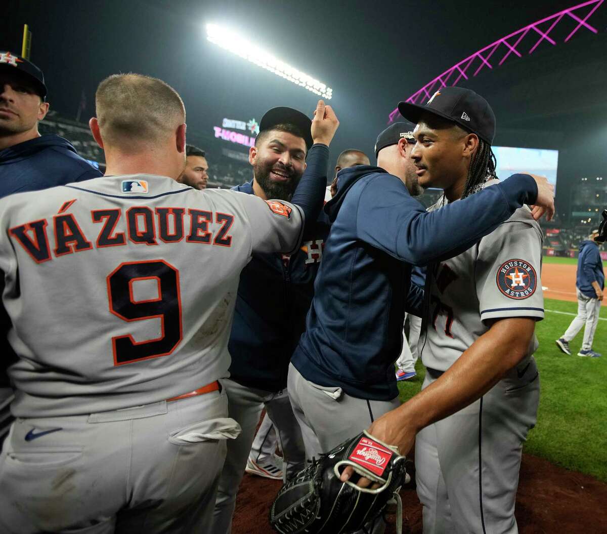 Houston Astros' Alex Bregman, left, points to a camera after hitting a home  run as catcher Christian Vazquez looks to the camera too during the eighth  inning of a baseball game against