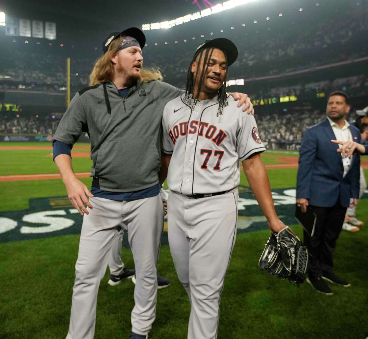 Houston Astros relief pitchers Ryne Stanek (45) and Luis Garcia (77) hug after wining Game 3 of baseball’s American League Division Series at T-Mobile Park on Saturday, Oct. 15, 2022 in Seattle.