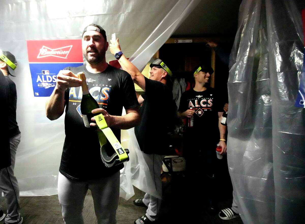 Houston Astros starting pitcher Justin Verlander (35) celebrates in the clubhouse after wining Game 3 of baseball’s American League Division Series at T-Mobile Park on Saturday, Oct. 15, 2022 in Seattle.