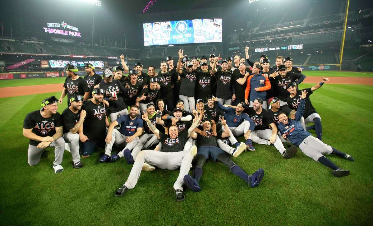 Houston Astros players celebrate with a team photo on the field after wining Game 3 of baseball’s American League Division Series at T-Mobile Park on Saturday, Oct. 15, 2022 in Seattle.