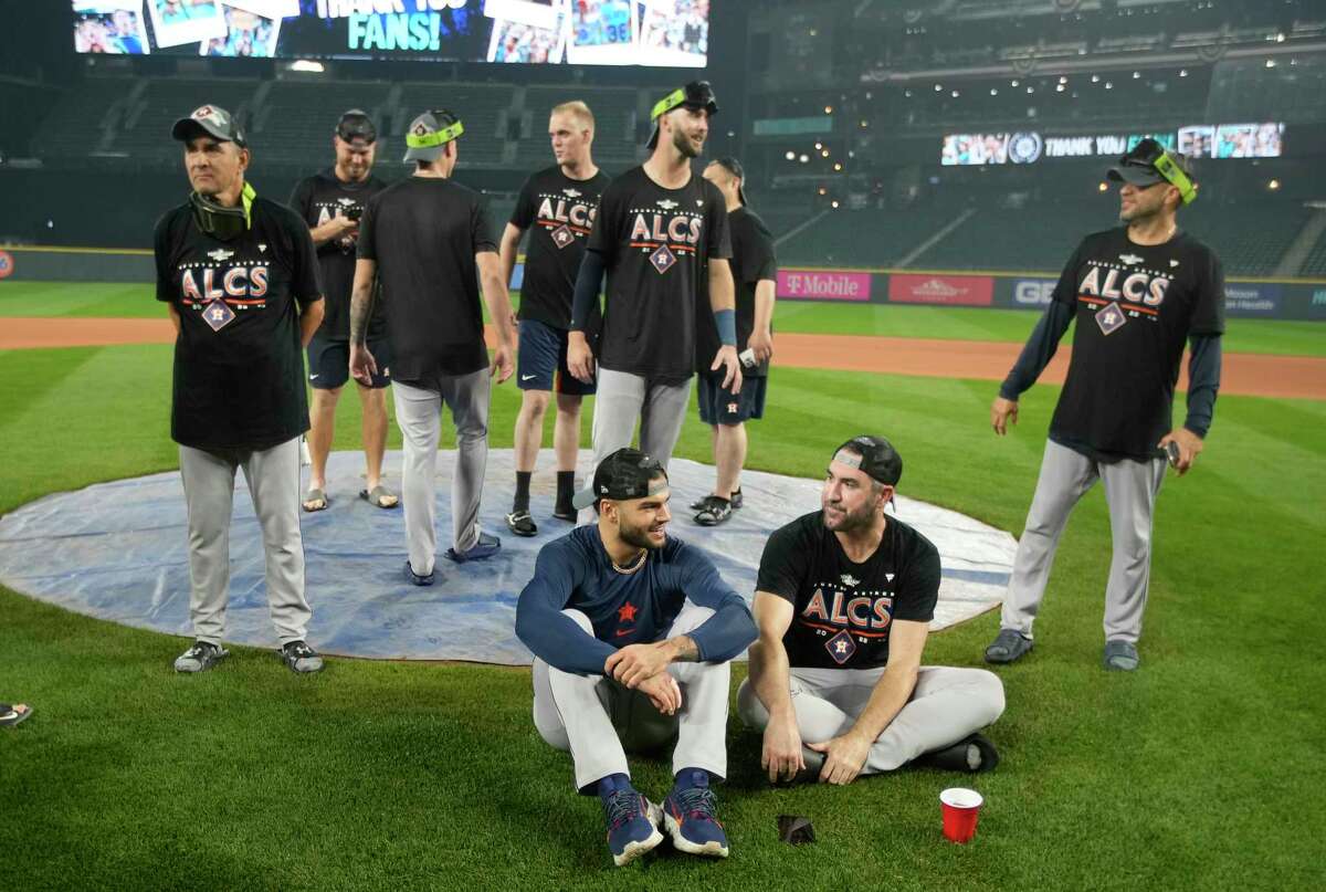 Houston Astros starting pitchers Lance McCullers Jr.and Justin Verlander wait for a team photo on the field after wining Game 3 of baseball’s American League Division Series at T-Mobile Park on Saturday, Oct. 15, 2022 in Seattle.
