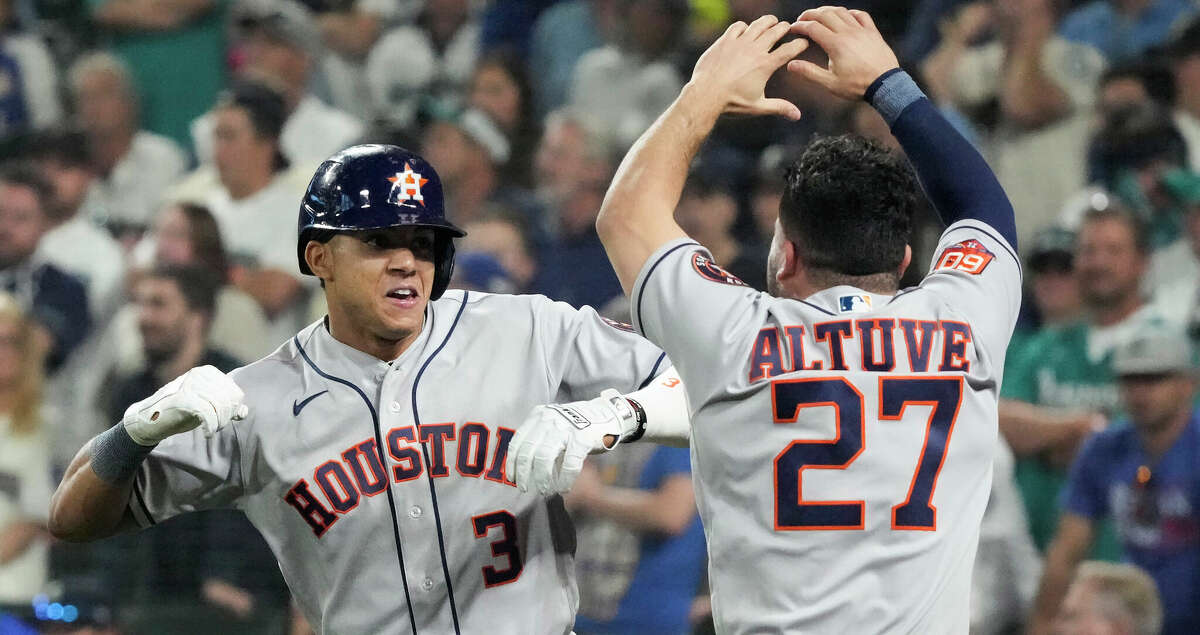 Houston Astros shortstop Jeremy Pena (3) and Jose Altuve celebrate Pena's solo home run against the Seattle Mariners during the 18th inning of Game 3 of the American League Division Series on Saturday, Oct. 15, 2022, in Seattle.
