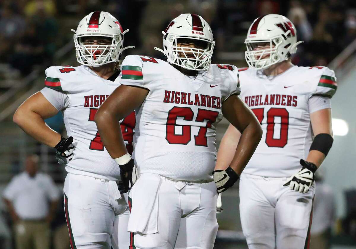 The Woodlands offensive lineman Andres Alcantara (67) is seen beside Koltin Sieracki (74) and Ryan Hughes (70) during the third quarter of a District 13-6A high school football game at Woodforest Bank Stadium, Friday, Oct. 14, 2022, in Shendoah.