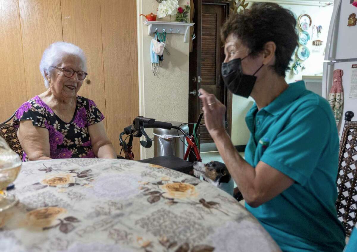 Bertha Casares, left, talks Thursday in her apartment with community health worker Rita Pendergast during the promotora’s home visit. A new study conducted by UT Health San Antonio faculty found that one-third of the patients were able control their type 2 diabetes after building a relationship with promotores.