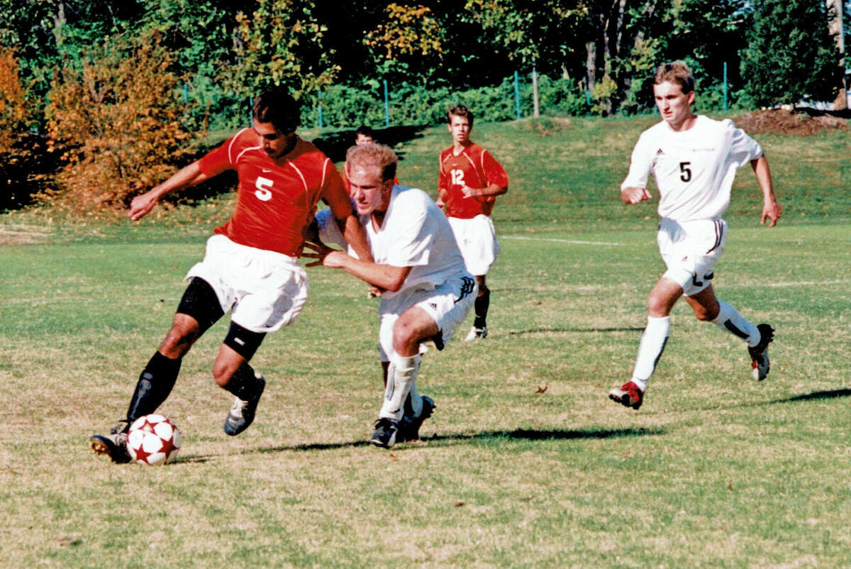Edwardsville’s Jason Emmanuel, left, controls the ball during his senior season with the Tigers in 2004.