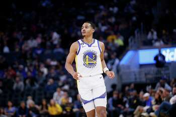 Golden State Warriors' Jordan Poole (3) reacts to San Francisco 49ers' Deebo  Samuel on the sideline after hitting a shot in the second half of an NBA  basketball game against the Memphis