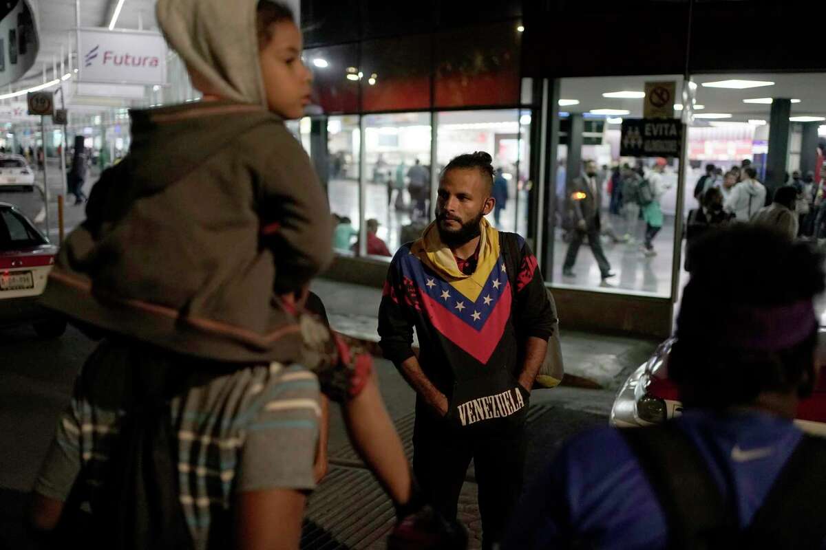 FILE - Venezuelan migrants wait for a bus to take them north, at the Northern Bus Station in Mexico City, Oct. 13, 2022. President Joe Biden last week invoked a Trump-era rule known as Title 42, which Biden's own Justice Department is fighting in court, to deny Venezuelans fleeing their crisis-torn country the chance to request asylum at the border. The rule, first invoked by Trump in 2020, uses emergency public health authority to allow the United States to keep migrants from seeking asylum at the border, based on the need to help prevent the spread of COVID-19. (AP Photo/Eduardo Verdugo, File)