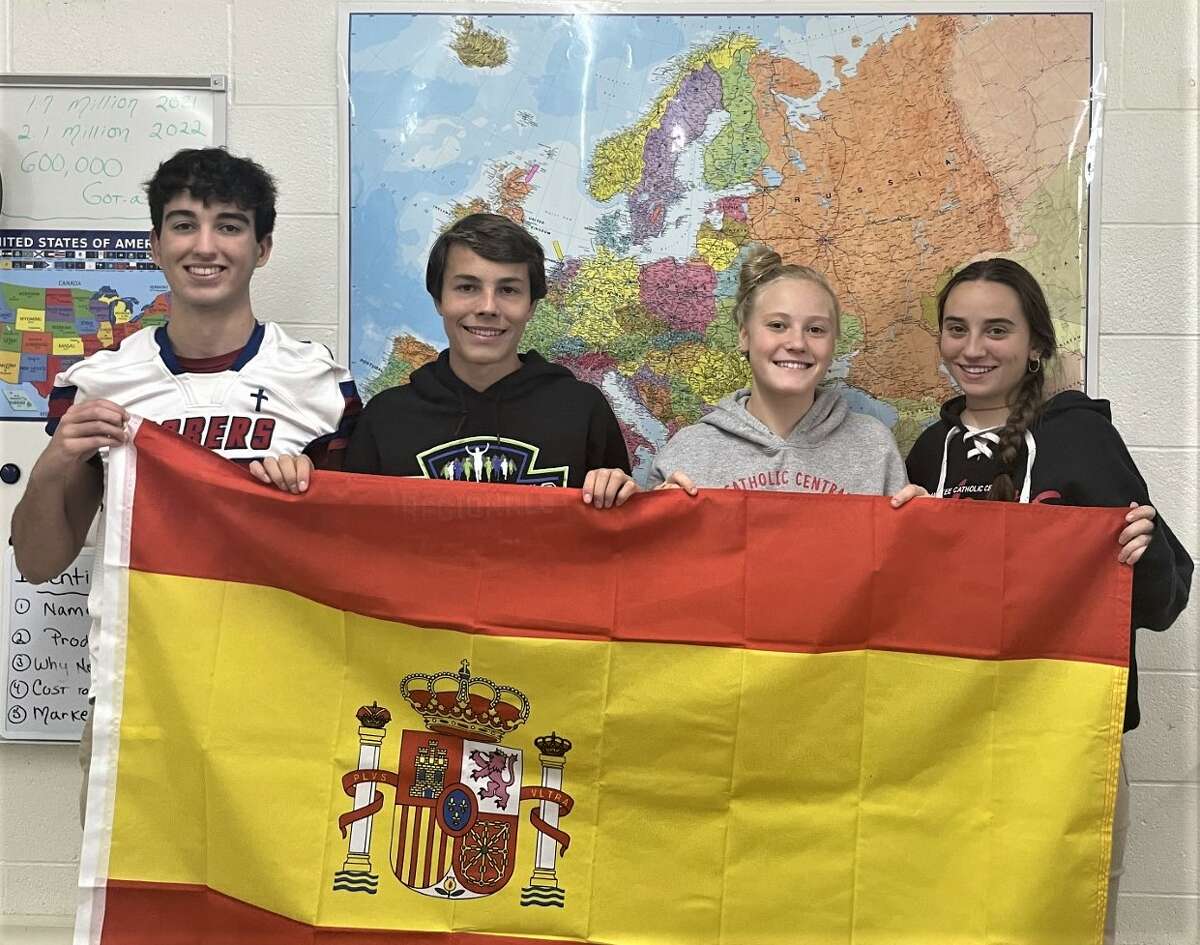 Manistee Catholic Central foreign exchange student Diego Gamarro (left), host students Peter Hybza and Grace Kidd, and foreign exchange student Angela Ramiro celebrate Spanish heritage and culture during Suzanne Robinson's social studies class.