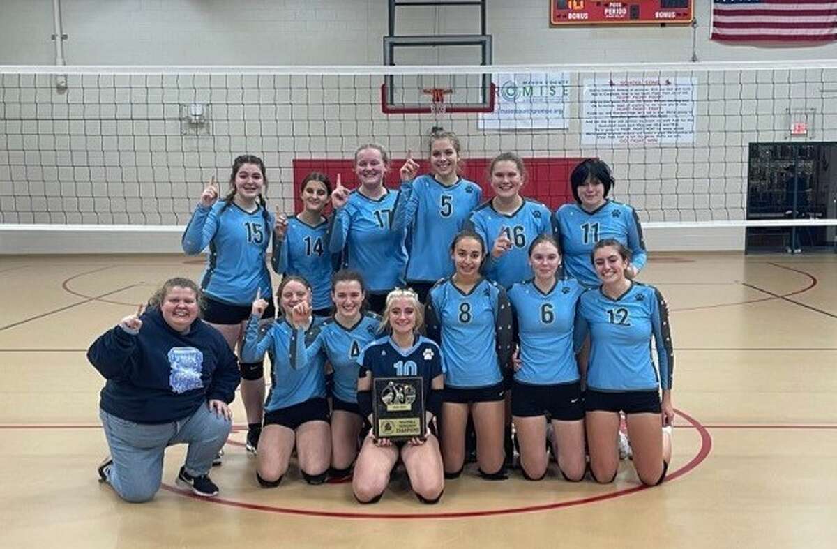 The Brethren volleyball team poses with its 2022 West Michigan D League championship trophy on Oct. 15 at Mason County Eastern High School. 