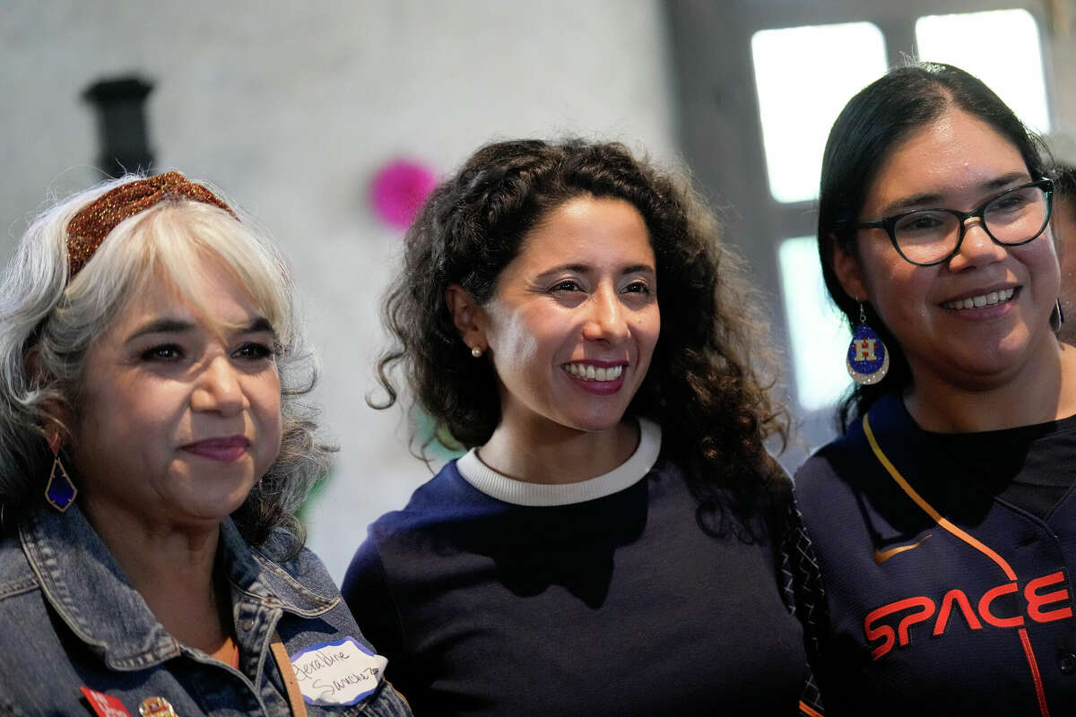 Harris County Judge Lina Hidalgo takes a photograph with supporters Geraldine Sanchez, left, and her daughter, Sandy Lynn Sanchez, at Una Tarde en East End, a rally for Latino officials and candidates, Saturday, Oct. 15, 2022, at Historic Firehouse No. 2 in Houston.
