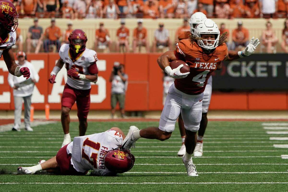 Jordan Whittington is tripped up by Iowa State defensive back Beau Freyler after a catch during the first half of Saturday’s game in Austin.