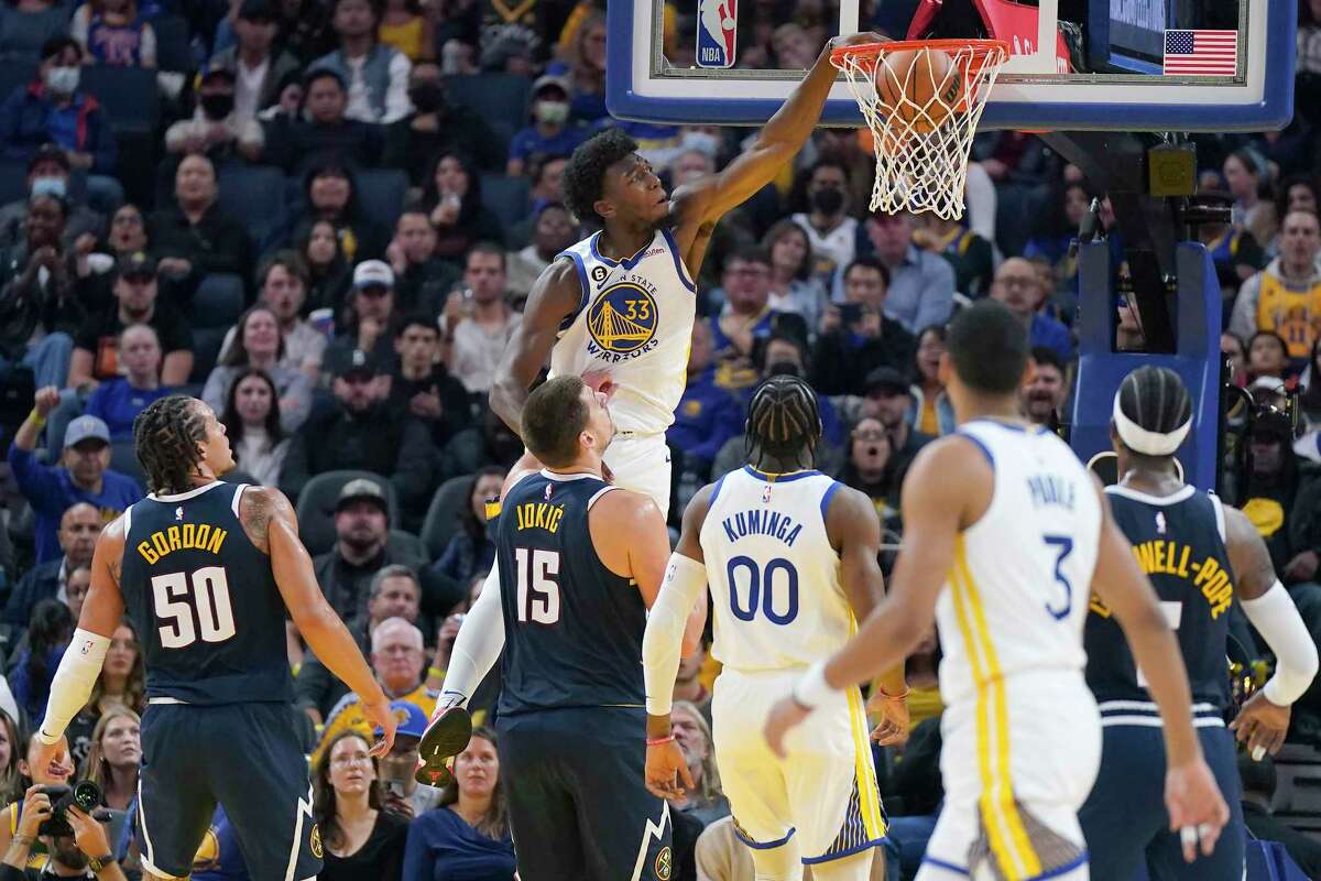 Golden State Warriors center James Wiseman (33) dunks against the Denver Nuggets during the first half of an NBA preseason basketball game in San Francisco, Friday, Oct. 14, 2022. (AP Photo/Jeff Chiu)
