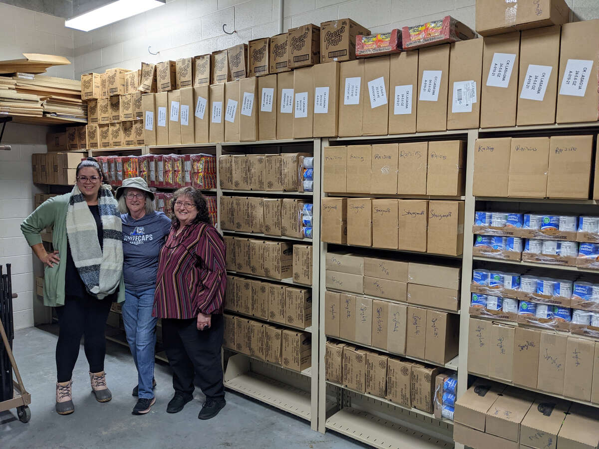 Volunteers with the Rotary Club of Baldwin unload and store food to distribute to Baldwin students through the BackPack Program.