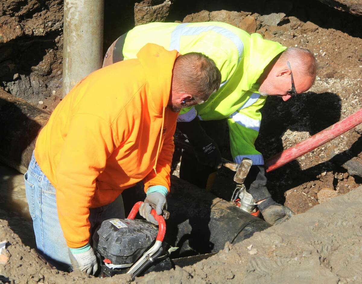 Workers cut through a section of 12-inch water main while repairing a break near N. Wood River Avenue between Ferguson and Madison avenues in Wood River Tuesday morning. The 12-inch main broke Monday. Most of the town was impacted, and anybody experiencing a loss of water pressure will be under a boil order once the repairs are completed.