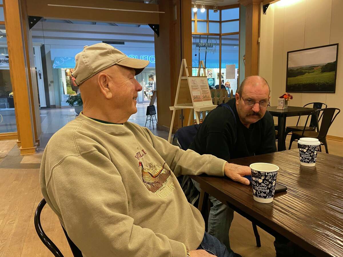 Midland residents George Yost and Kenny Letts chat over warm drinks on Oct. 14, 2022 at Cultivate Coffee & Tea in the Midland Mall.