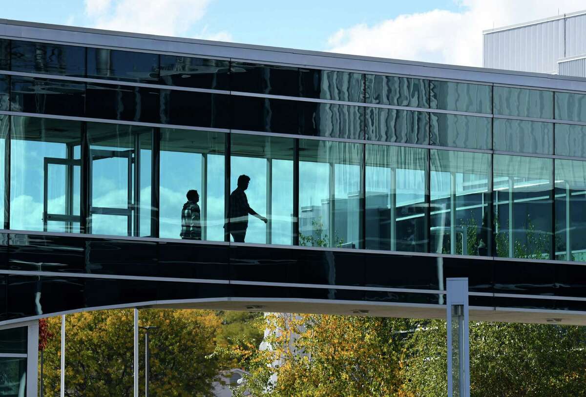 People head across the walkway at Albany NanoTech Complex where U.S. Senate Majority Leader Charles Schumer called for legislation that would block China’s semiconductor supply from entering the U.S. defense sector and boost state chip manufacturing on Tuesday, Oct. 18, 2022, in Albany, N.Y.