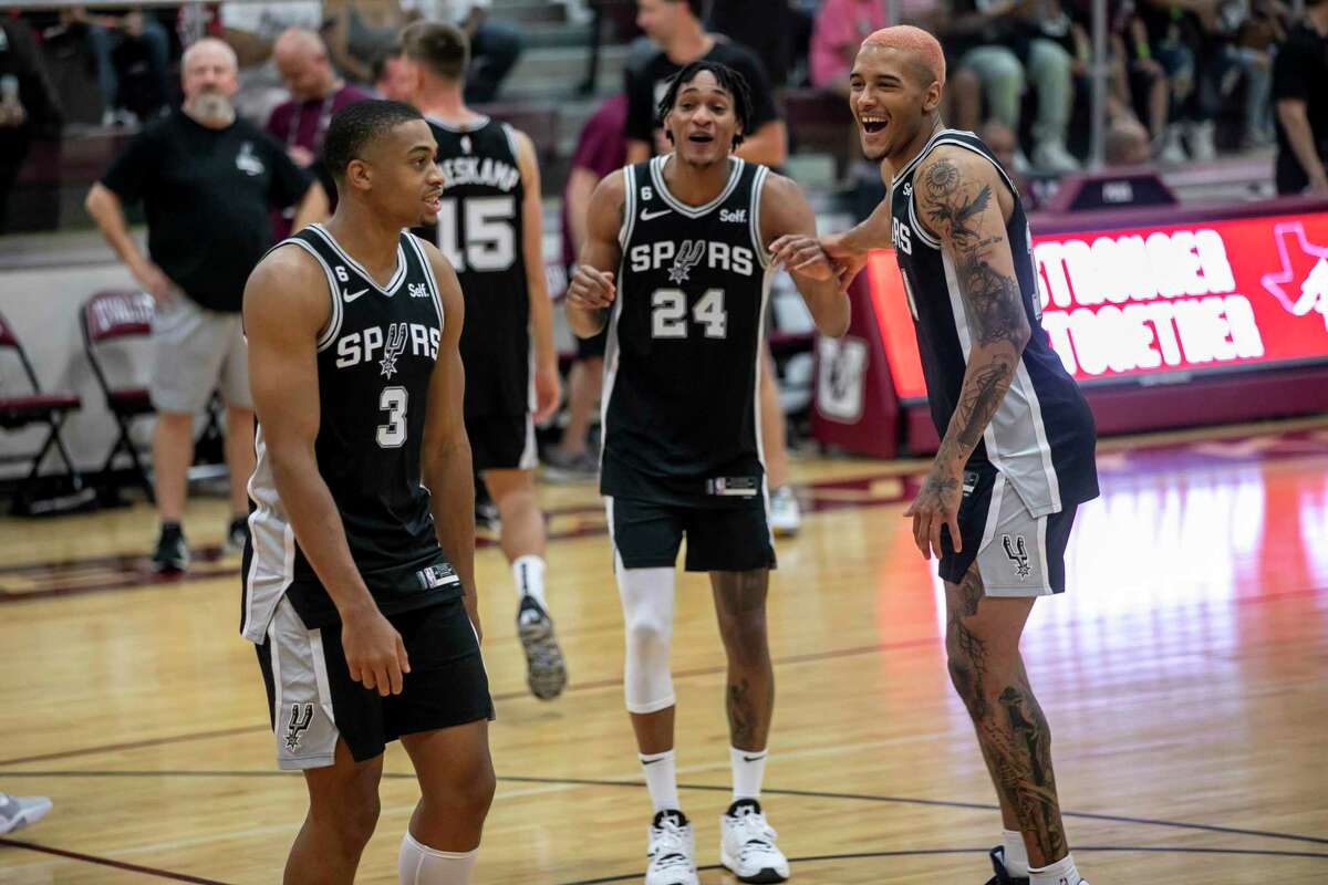 From left, San Antonio Spurs’ Keldon Johnson (3), Devin Vassell (24) and Jeremy Sochan (10) share a laugh together during a Spurs’ practice held at Uvalde High School's Harvey Kinchlow Gym in Uvalde, TX, on Oct. 8, 2022.