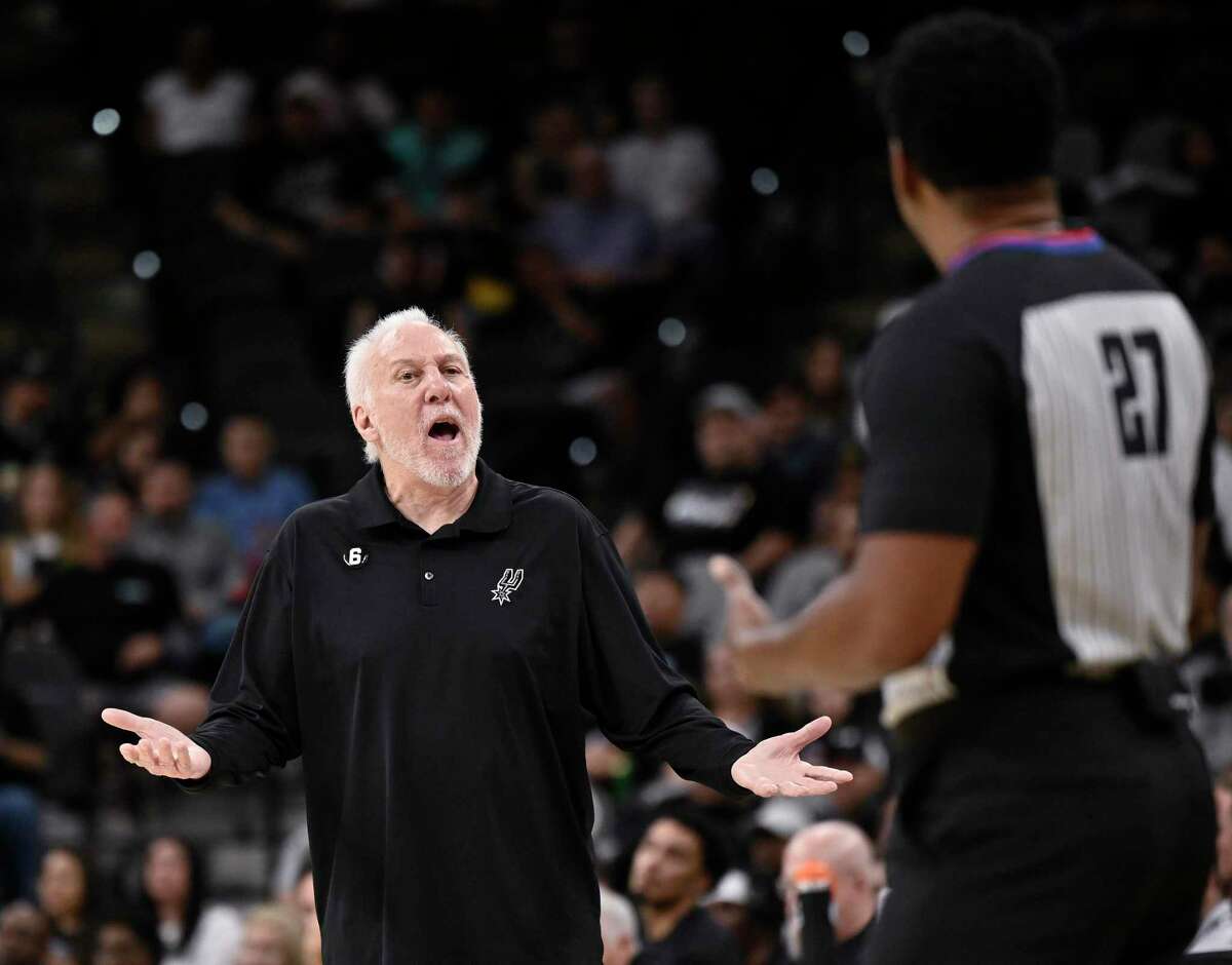 San Antonio Spurs coach Gregg Popovich, left, yells to referee Mitchell Ervin during the first half of the team's preseason NBA basketball game against the Oklahoma City Thunder, Thursday, Oct. 13, 2022, in San Antonio. (AP Photo/Darren Abate)