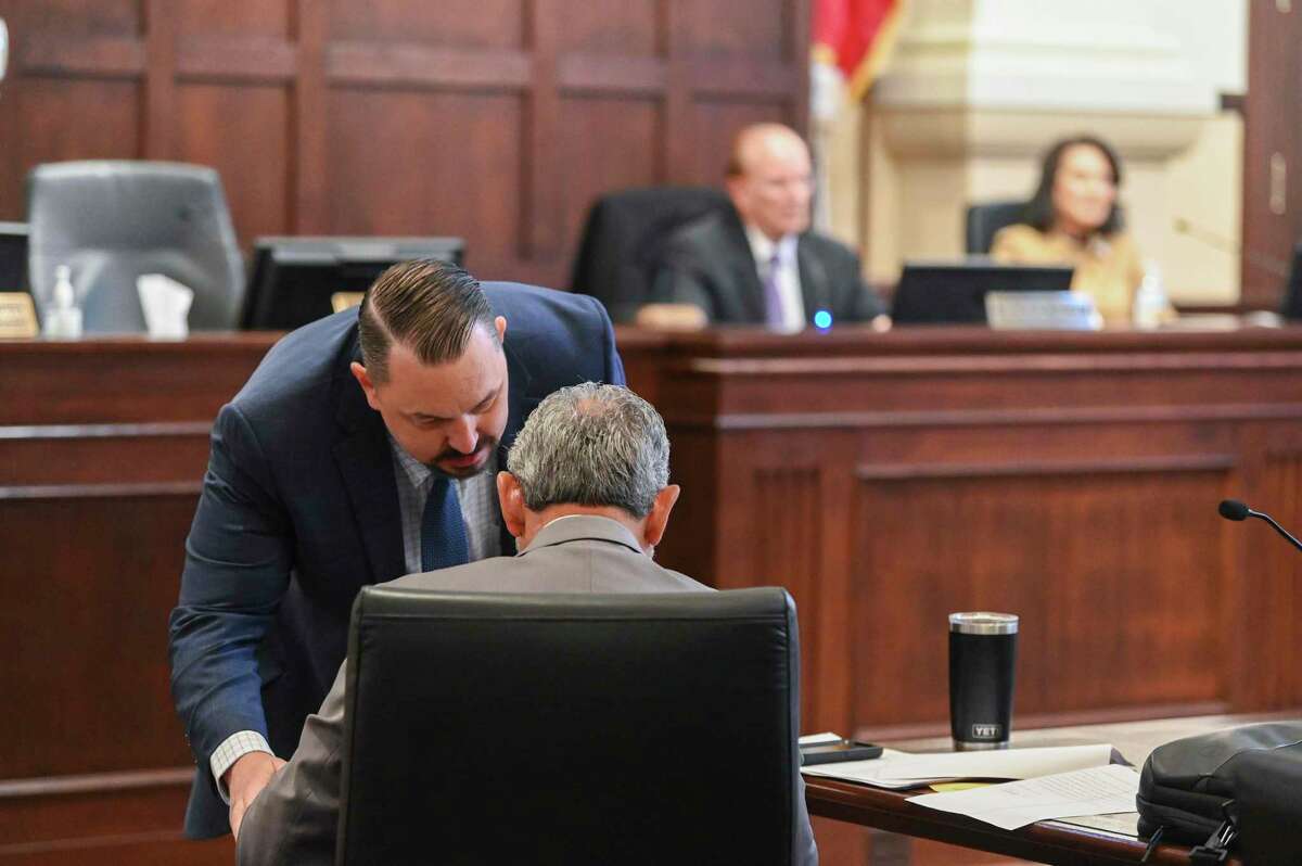 Larry Roberson, left, assistant district attorney and chief of the civil division of the Bexar County District Attorney’s Office, whispers to Joe Gonzales, Bexar County district attorney, during a Bexar County Commissioners meeting on Tuesday, Oct. 18, 2022. The commissioners voted to have 302 polling locations in the county.