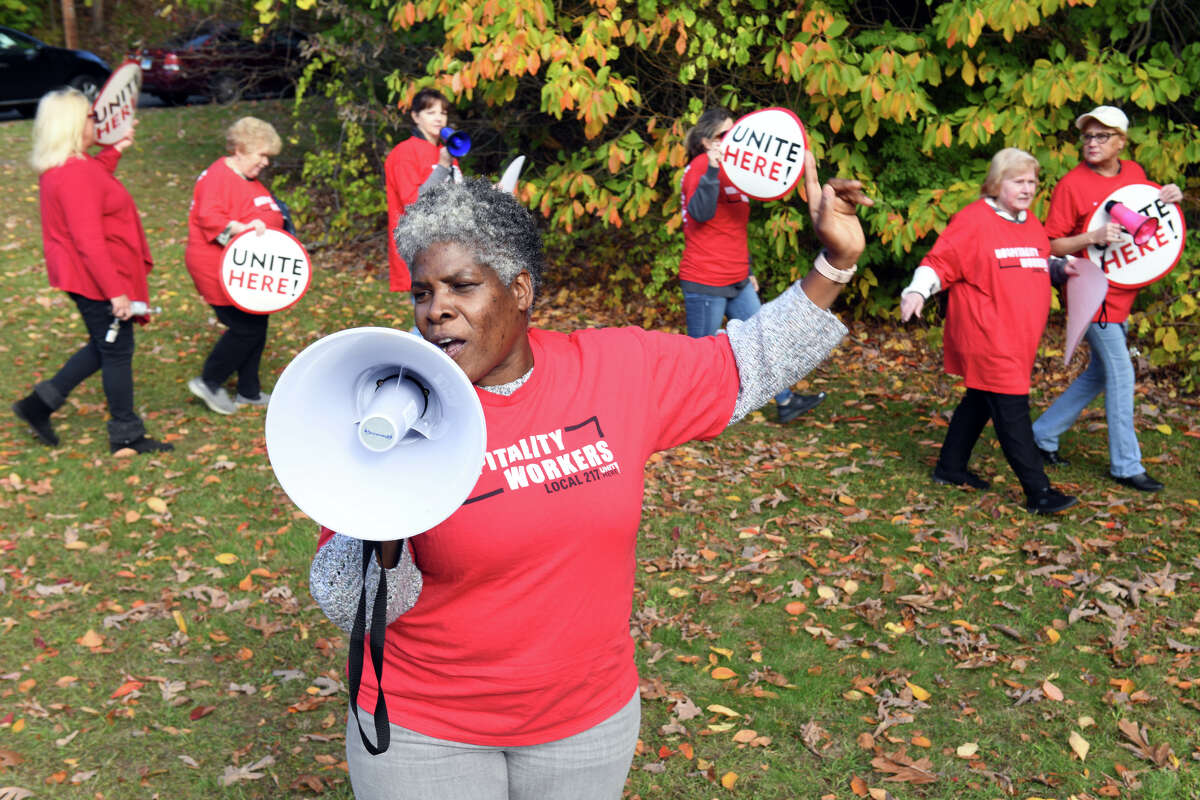 Diana St. Mark, an organizer for Unite Here Local 217, leads a protest rally near Sunnyside Elementary School, in Shelton, Conn. Oct. 18, 2022.