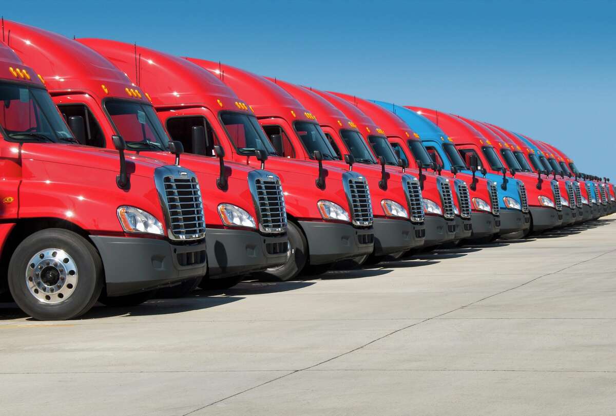 A stock photo shows a fleet of red semi-trucks parked in Jackson, Tenn. 