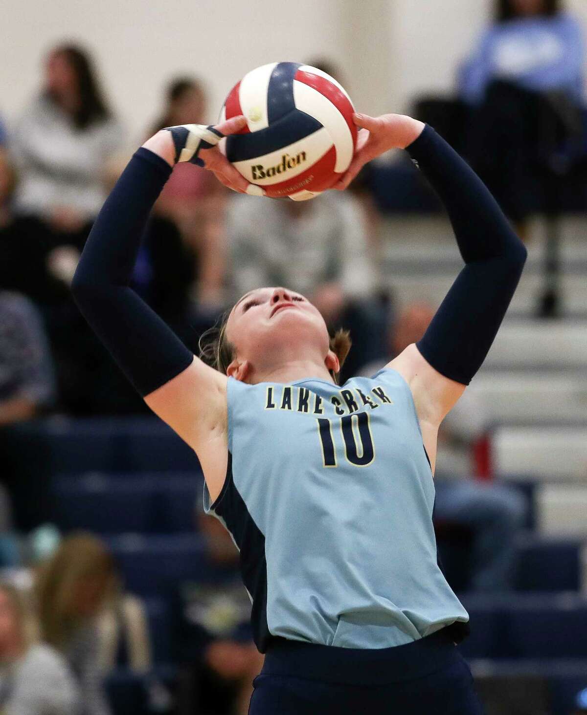 Lake Creek's Lauren Greene (10) sets the ball in the second set of a District 21-5A high school volleyball match at Lake Creek High School, Tuesday, Oct. 18, 2022, in Montgomery.