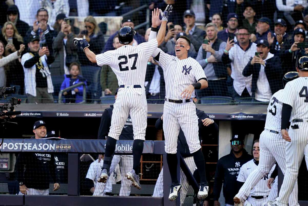 The New York Yankees’ Giancarlo Stanton (left) celebrates with Aaron Judge after hitting a three-run homer in the first inning.