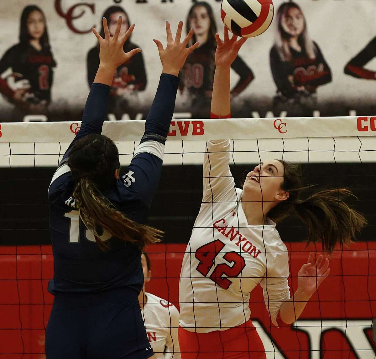 New Braunfels Canyon’s Courtney Pope (42) looks to hit over Smithson Valley’s Megan Zamora (15) during volleyball in New Braunfels on Tuesday, Oct. 18, 2022.