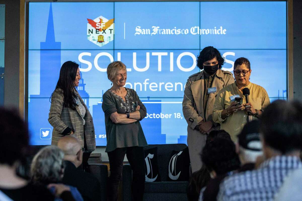 Attendees speak on stage during the SFNext Solutions Conference at the Exploratorium in San Francisco, California Tuesday, Oct. 18, 2022.