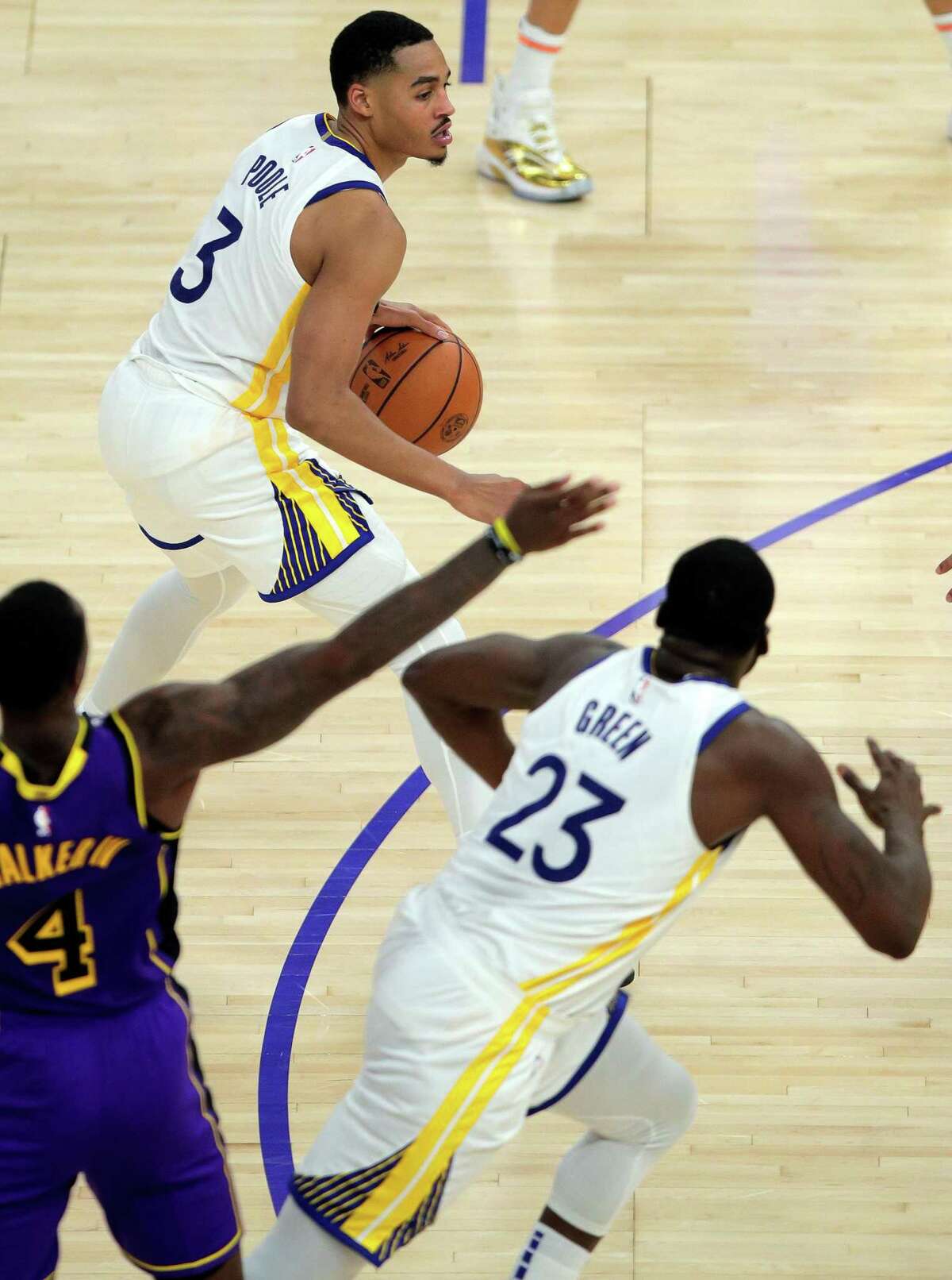 Jordan Poole (3) sees Draymond Green (23) with a clear lane before passing to him for a basket in the first half as the Golden State Warriors played the Los Angeles Lakers in their home opener at Chase Center in San Francisco, Calif., on Tuesday, October 18, 2022.