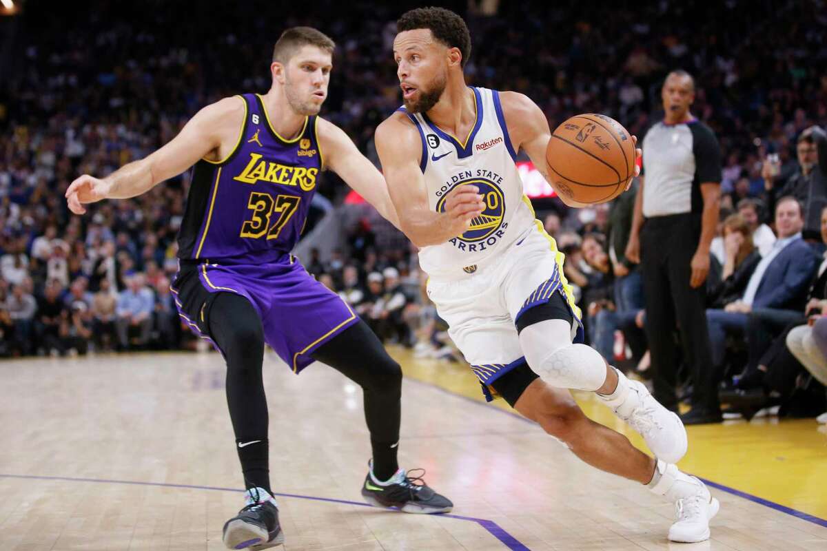 Golden State Warriors guard Stephen Curry (30) against Los Angeles Lakers forward Matt Ryan (37) in the third quarter of an NBA game at Chase Center in San Francisco, Calif., Tuesday, Oct. 18, 2022. The Warriors won 123-109 in their home opener.