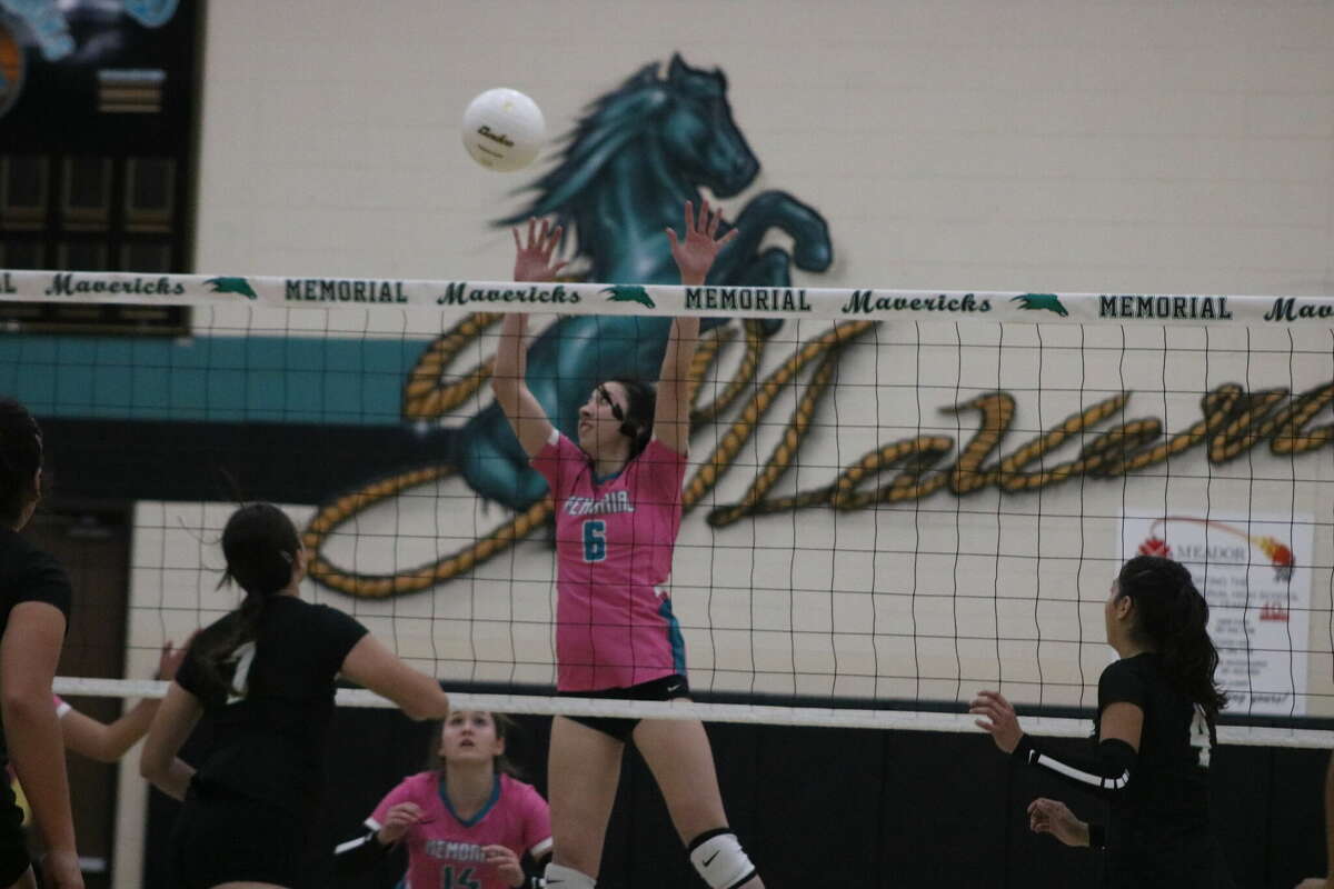 Memorial's Bianca Burnett (6) goes up for the block during the early portions of Tuesday night's district match.
