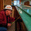 William Lafleur, carpenter with Three Rivers Corporation, works on the bar of the revamped Frick's Sports Bar on Oct. 18, 2022 in Midland.