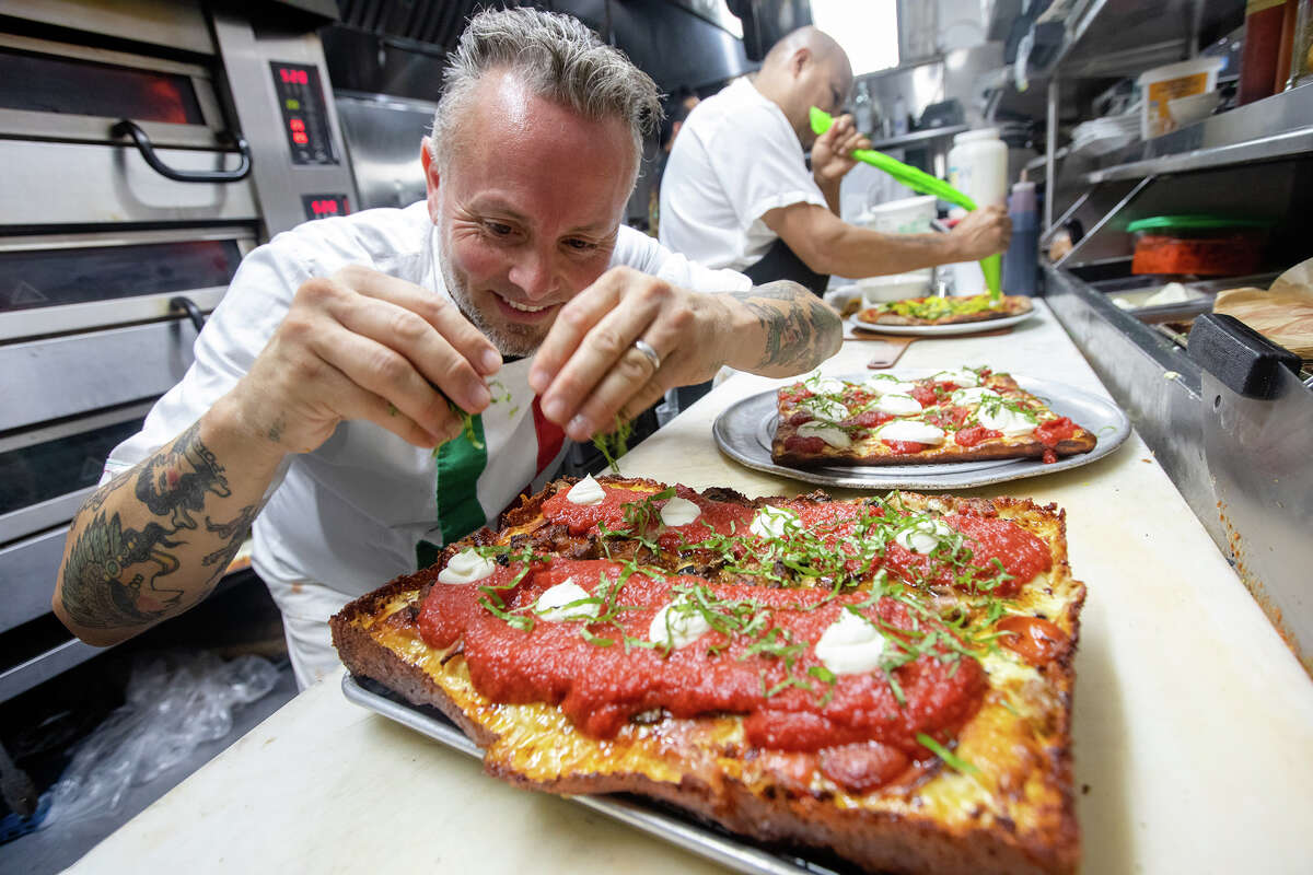 Owner Tony Gemignani puts a finishing touch on a Detroit-style pizza at Tony's Pizza Napoletana, a North Beach staple.