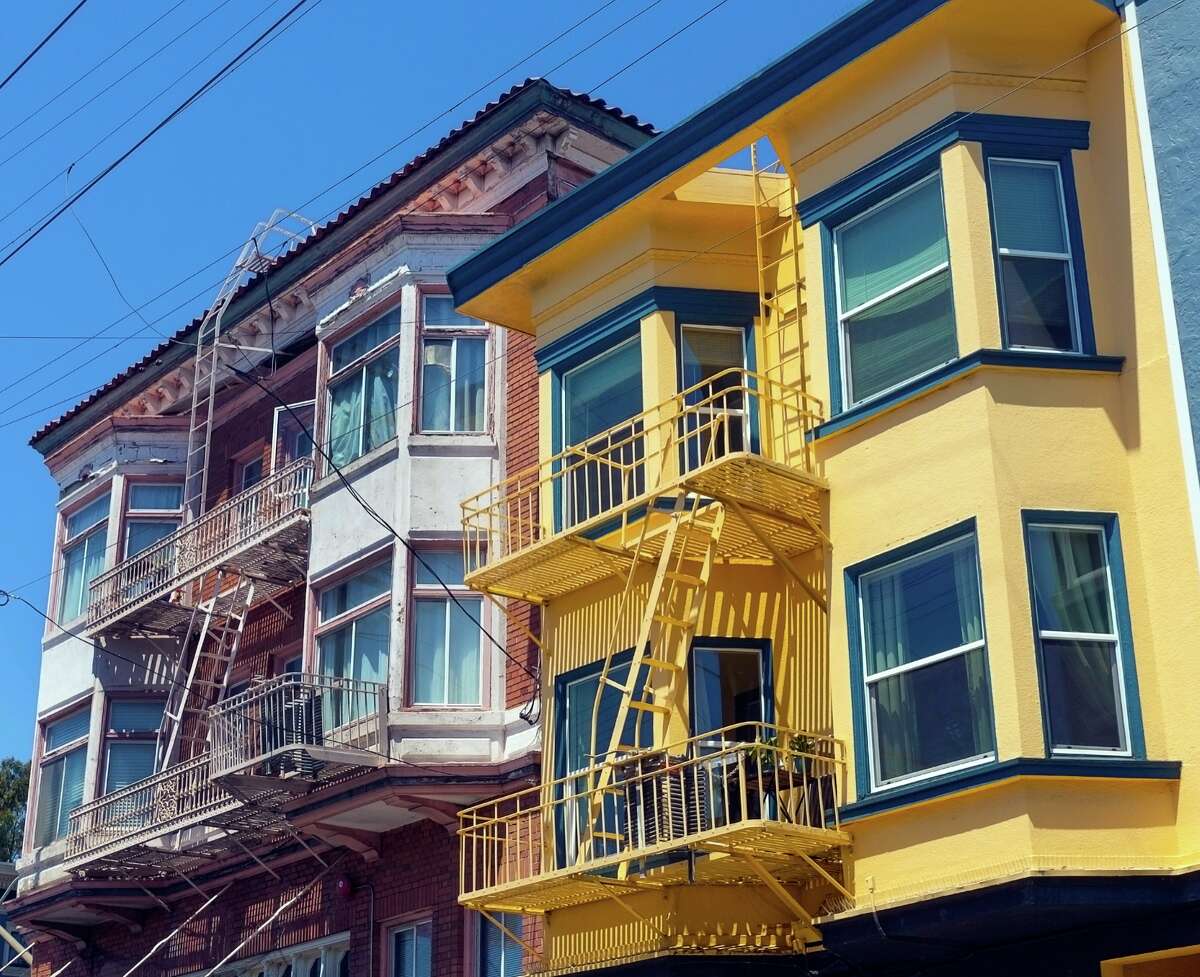 San Francisco apartment buildings with bay windows and fire escapes.