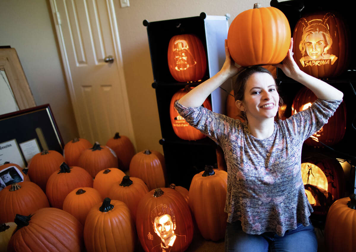 Courtney Wunder, 33, is an artist who uses a small drill to carve intricate designs in foam pumpkins for holiday decorations, Tuesday, Oct. 18, 2022, in Pearland.