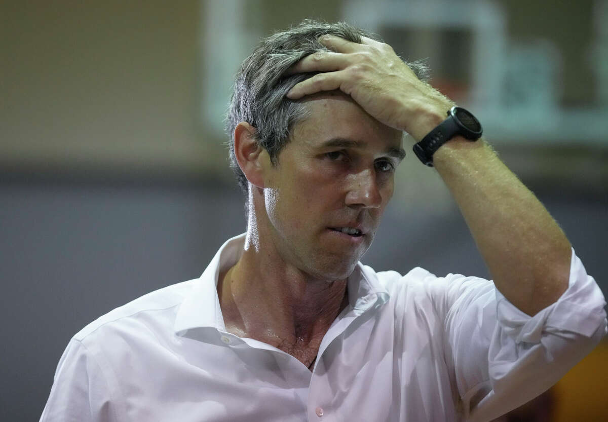 Texas gubernatorial candidate Beto O'Rourke fixes hair while listening to a question from the crowd at Black Texans for Beto town hall Sunday, Oct. 9, 2022, at Tidwell Community Center in Houston.