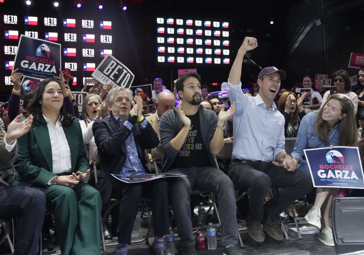 Democratic gubernatorial candidate Beto O'Rourke, fist raised, and Lin-Manuel Miranda, left of O'Rourke, cheer during a rally Tuesday Oct. 18, 2022, at Imagen Venues Escapade in Houston.