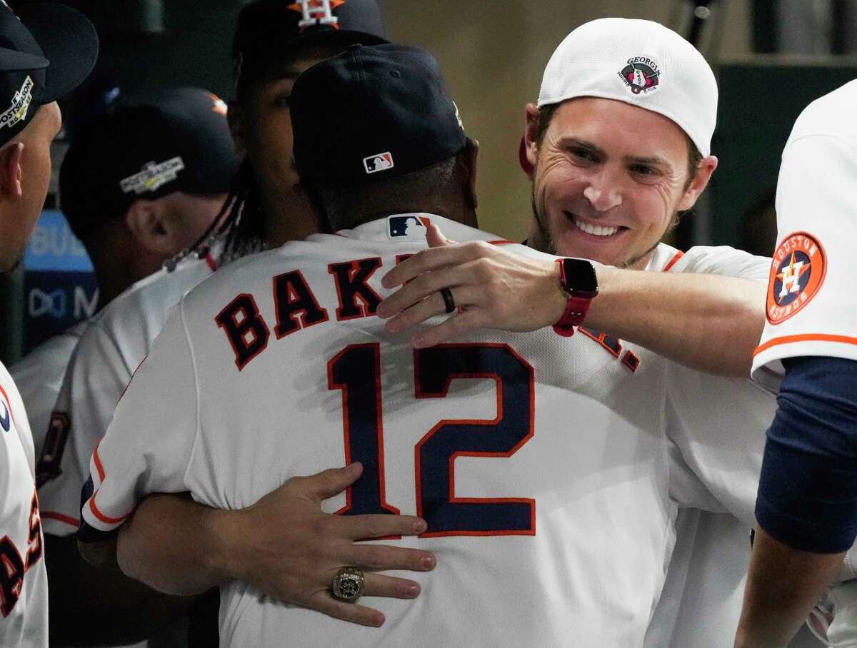 Former Houston Astros player Josh Reddick, right, hugs manager Dusty Baker Jr. (12) before Game 1 of the American League Championship Series at Minute Maid Park on Wednesday, Oct. 19, 2022, in Houston.