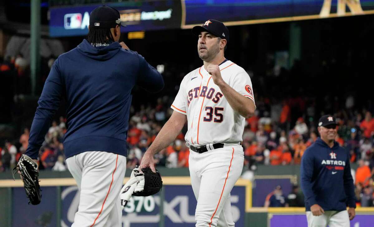 Houston Astros starting pitcher Justin Verlander, center, gets a fist-bump from Luis Garcia, left, as he walks toward the dugout before Game 1 of the American League Championship Series at Minute Maid Park on Wednesday, Oct. 19, 2022, in Houston.