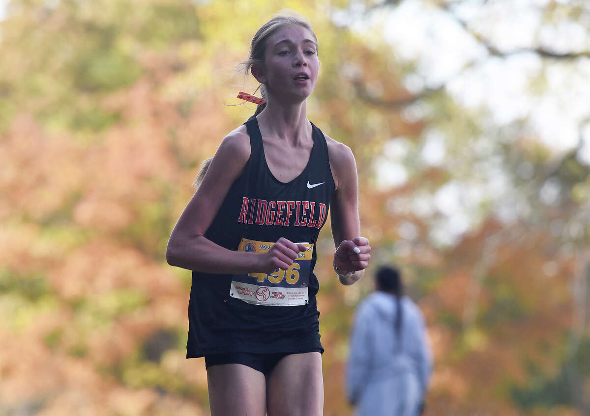 Ridgefield's Elizabeth Buonocore heads into the home stretch on her way to a win in the FCIAC girls cross country championship in New Canaan's Wavceny OPark on Wednesday, Oct. 19, 2022.