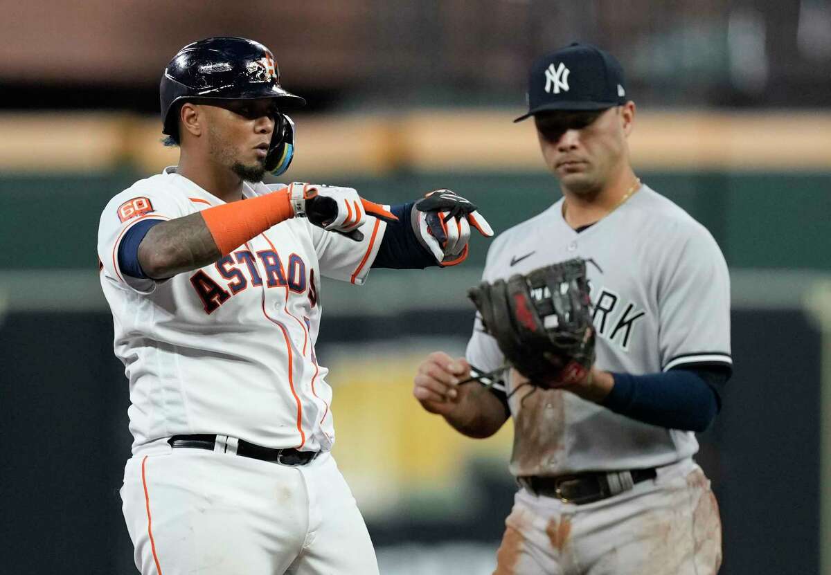 Normally light-hitting Astros catcher Martín Maldonado, left, surprised Yankees second baseman Gleyber Torres and the Yankees with a second-inning RBI double that tied Wednesday's ALCS opener at 1.  