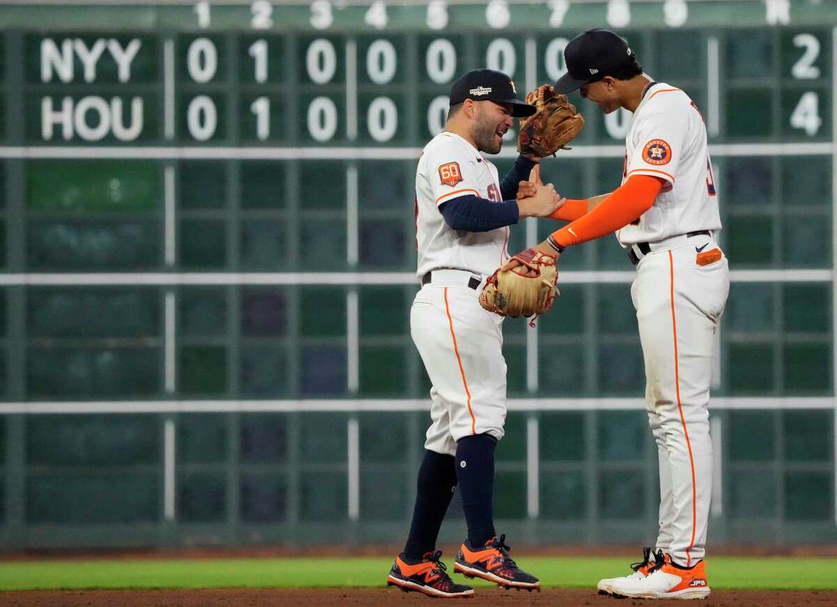 Houston Astros second baseman Jose Altuve (27) and shortstop Jeremy Peña (3) celebrate after defeating the New York Yankees 4-2 to win Game 1 of the American League Championship Series at Minute Maid Park on Wednesday, Oct. 19, 2022, in Houston.